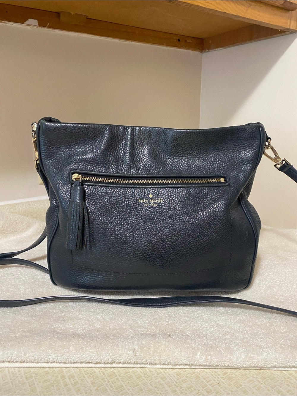 kate spade black pebbled leather crossbody with tassel and gold hardware